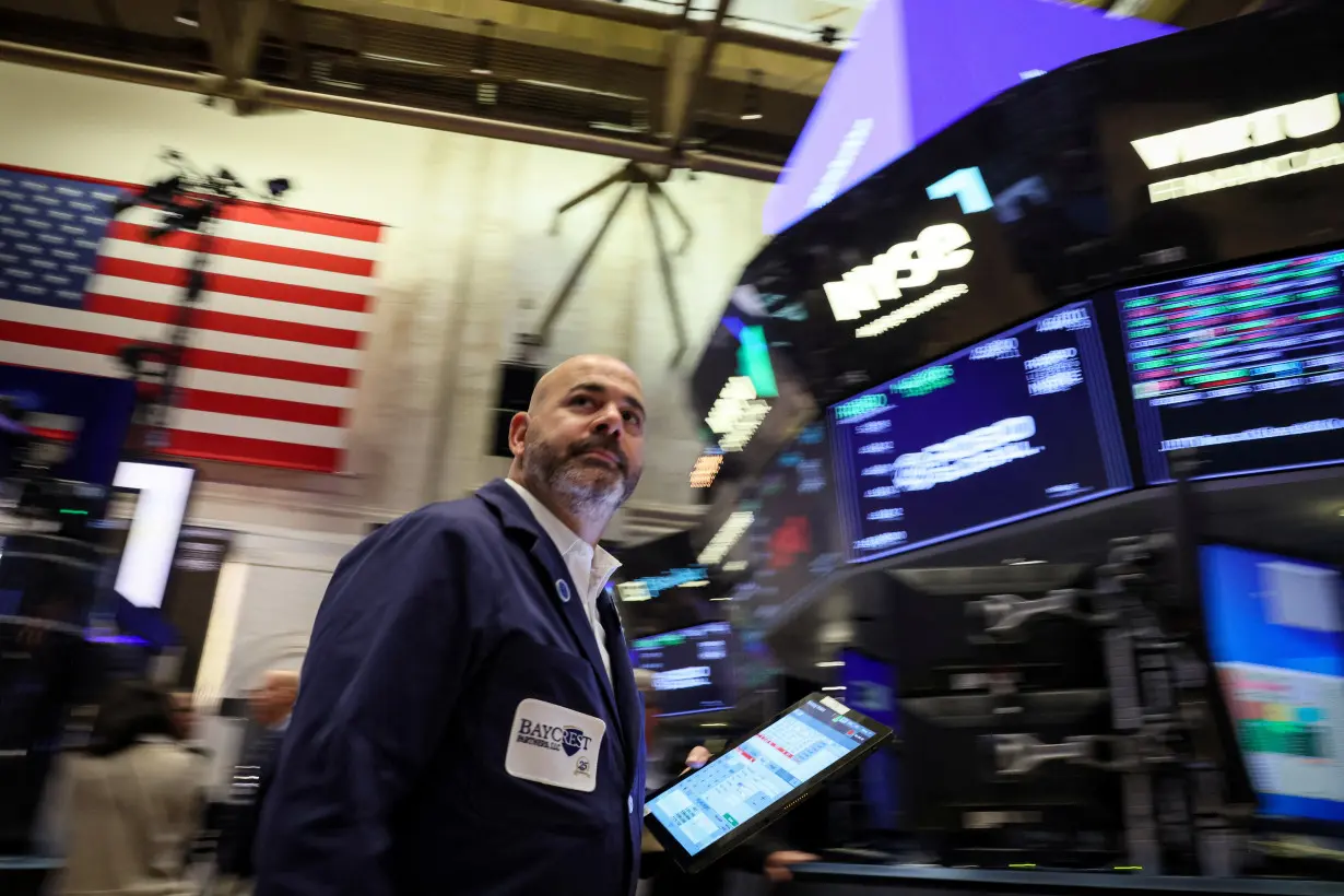 Traders work on the floor of the NYSE in New York