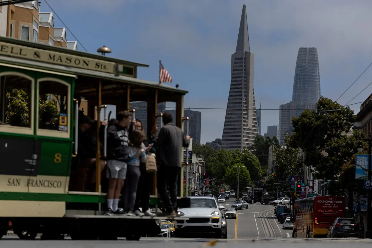 FILE PHOTO: The Transamerica Pyramid building is seen as tourists ride a cable car in downtown San Francisco