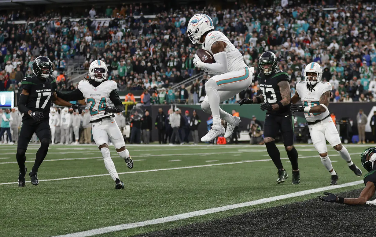 Hill's special TD catch and Holland's 99-yard INT return lead Dolphins past Jets 34-13