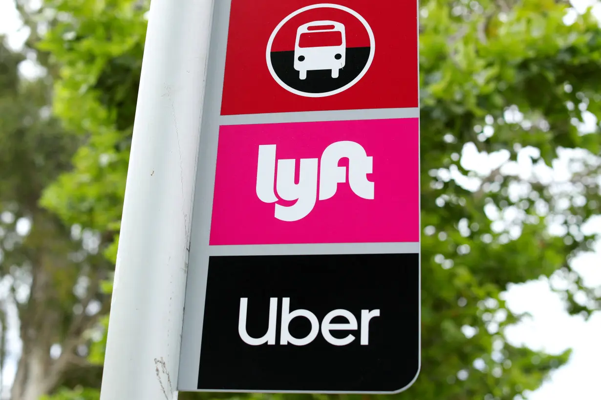 FILE PHOTO: A sign marks a rendezvous location for Lyft and Uber users at San Diego State University in San Diego