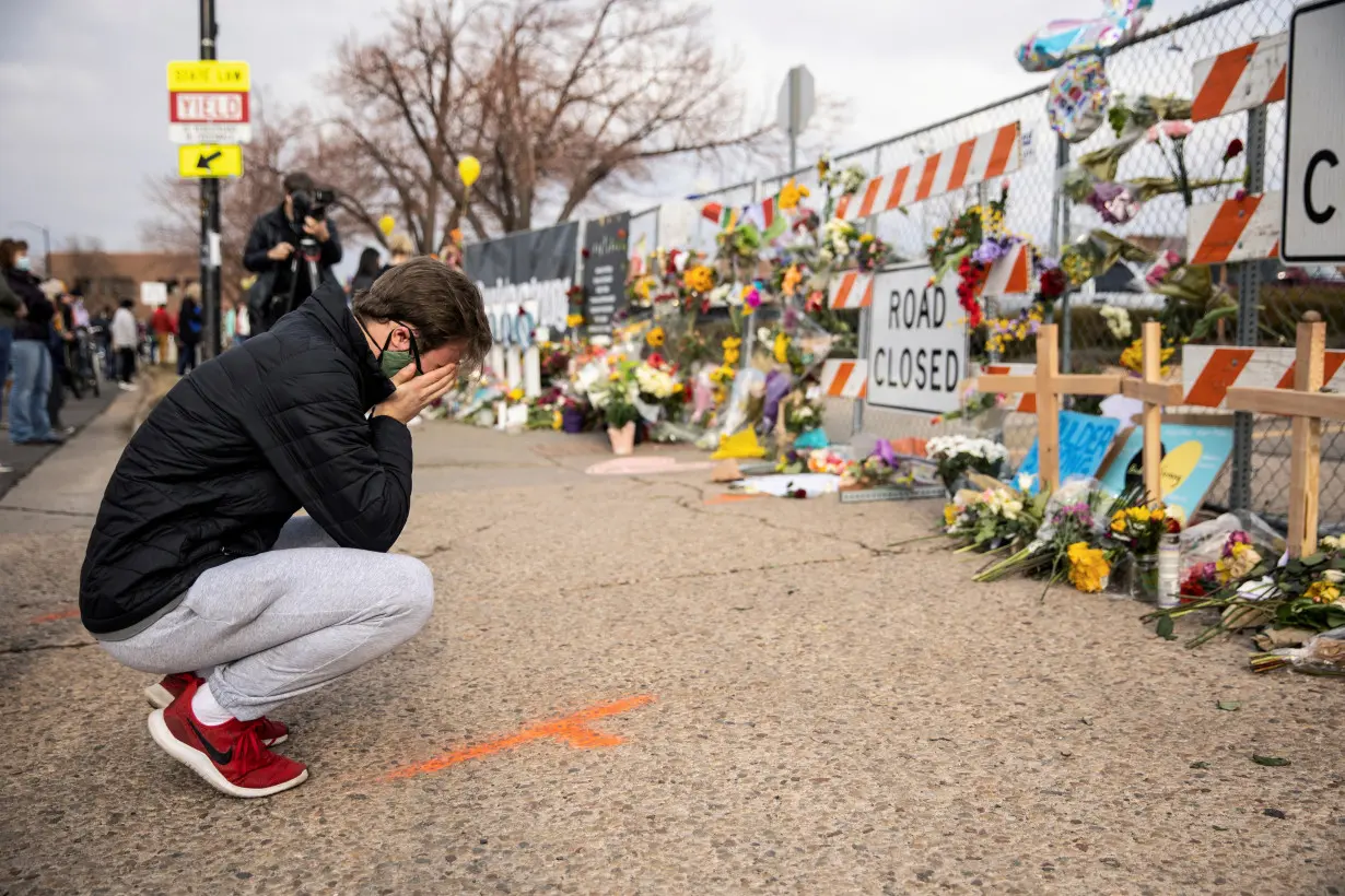 FILE PHOTO: A man cries at the site of a shooting at King Soopers grocery store in Boulder