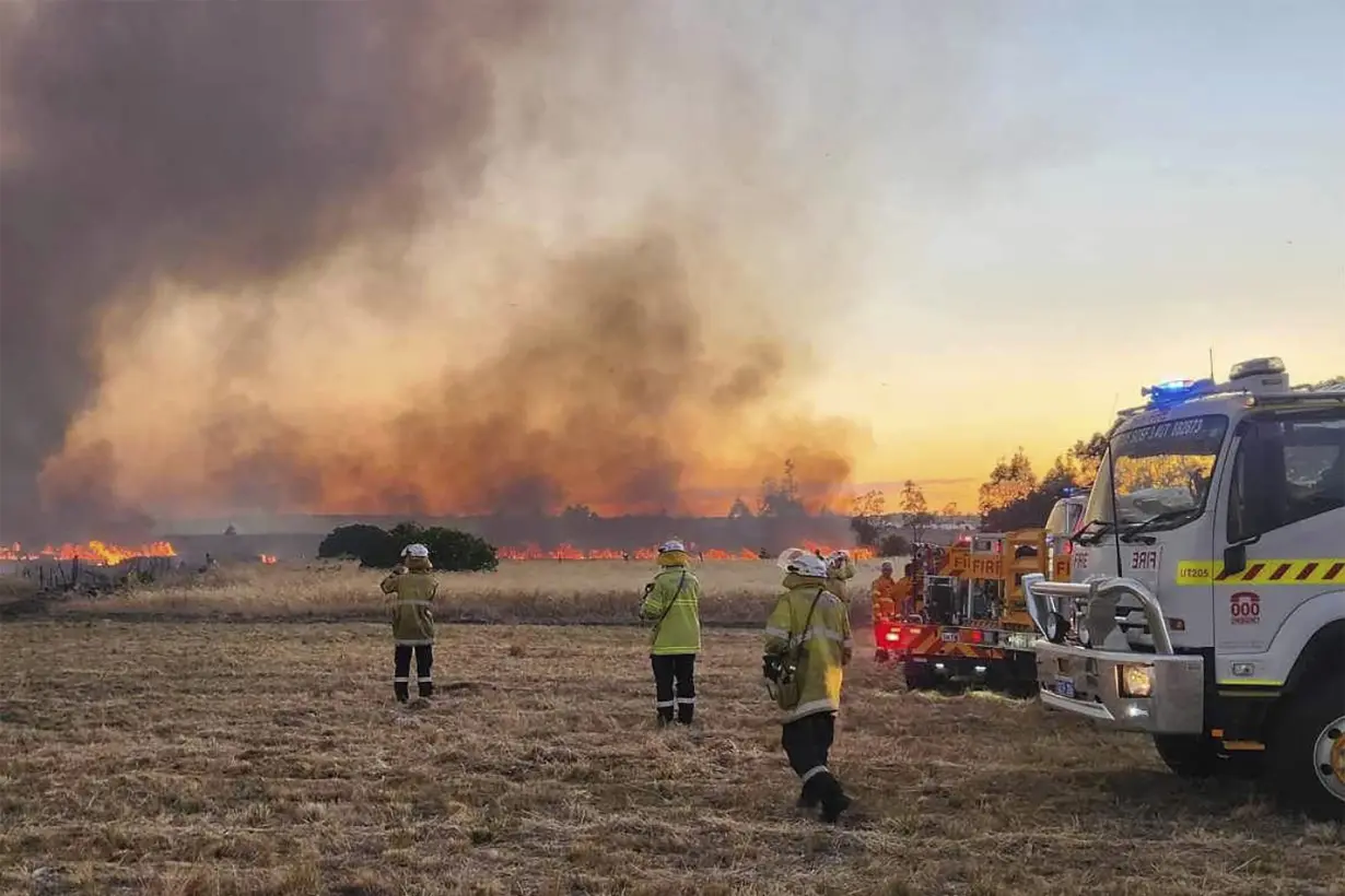 Dozens evacuate and 10 homes are destroyed by a wildfire burning out of control on the edge of Perth