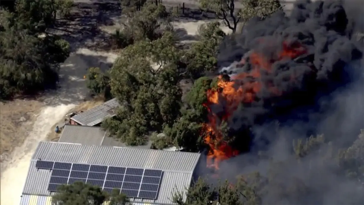 Dozens evacuate and 10 homes are destroyed by a wildfire burning out of control on the edge of Perth