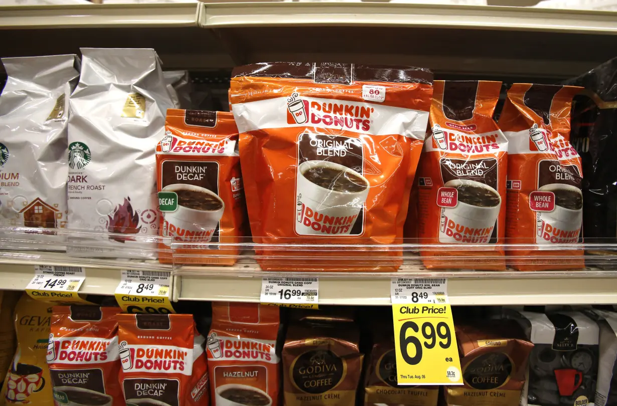 Dunkin' Donuts coffee packs are pictured alongside other coffee brands on the shelves of a grocery store in Pasadena