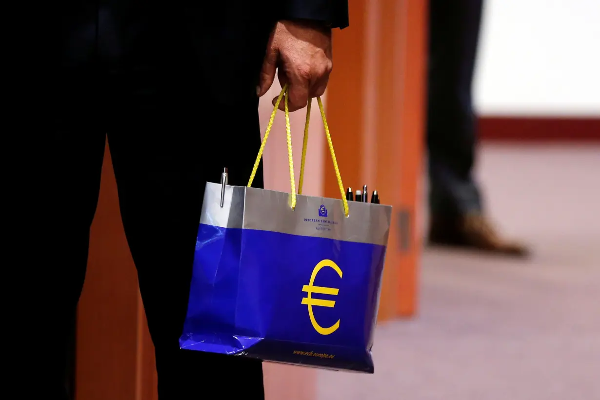 An official holds a bag with the euro logo during a eurozone finance ministers meeting in Brussels