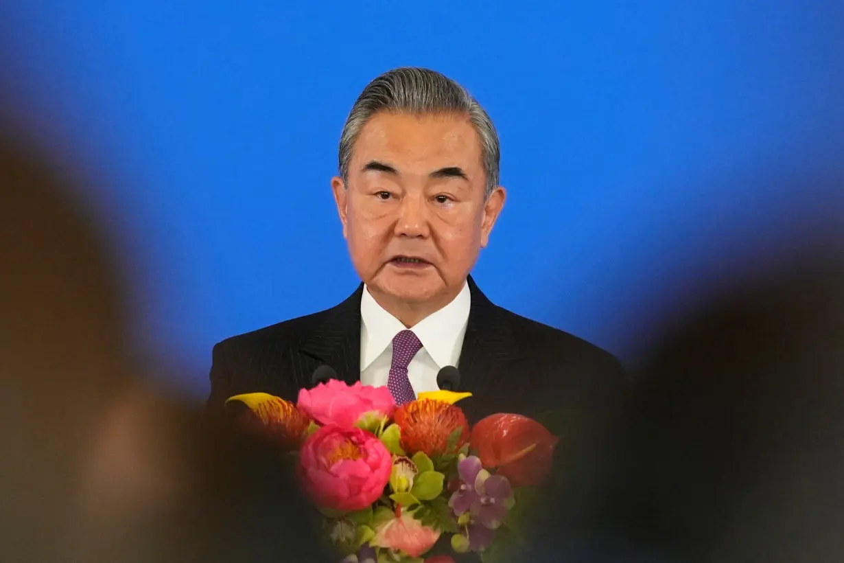 Chinese Foreign Minister Wang Yi speaks during the opening ceremony of the diplomatic symposium at the Diaoyutai State Guesthouse in Beijing