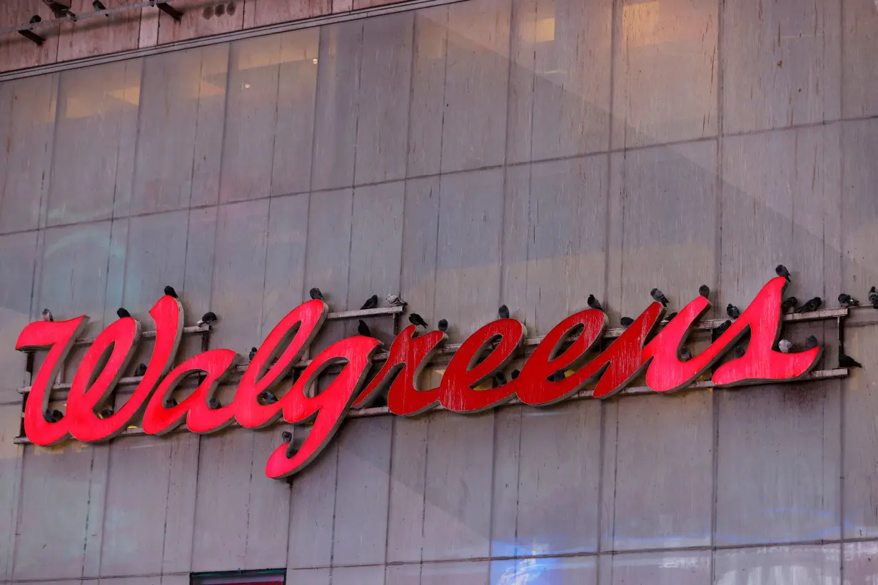 FILE PHOTO: Pigeons are seen resting on signage for Walgreens in New York City