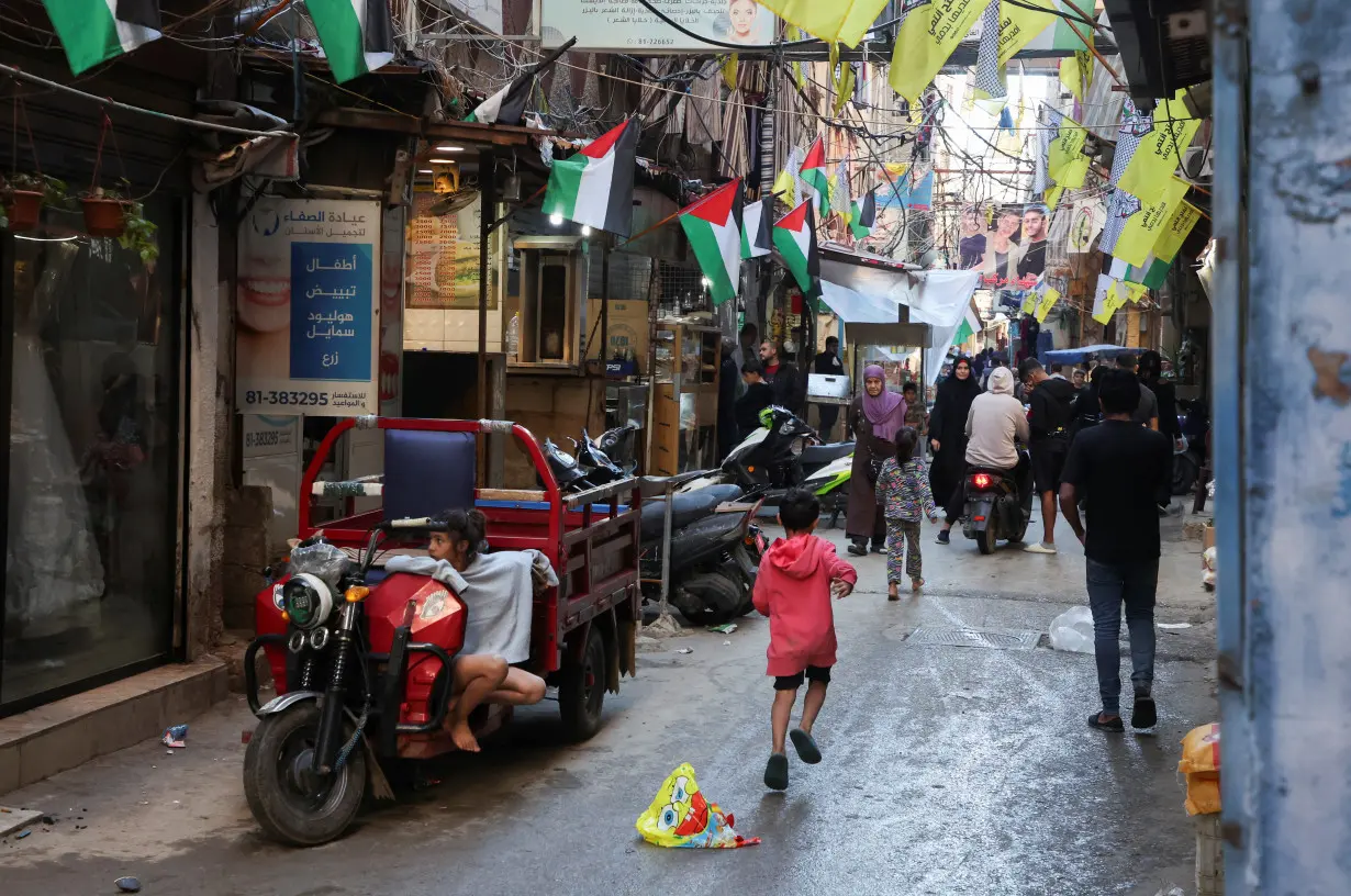 People walk in Shatila Palestinian refugee camp, in Beirut