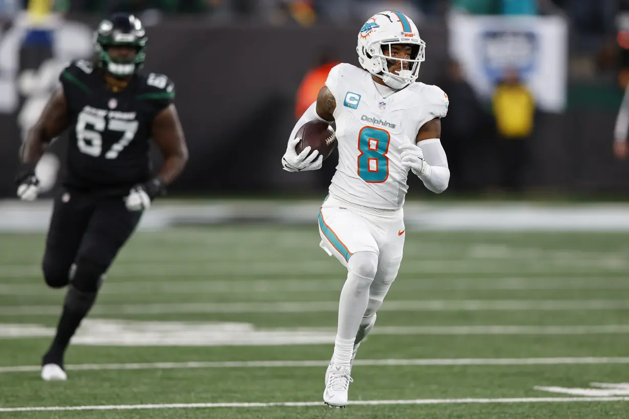 Hill's special TD catch and Holland's 99-yard INT return lead Dolphins past Jets 34-13