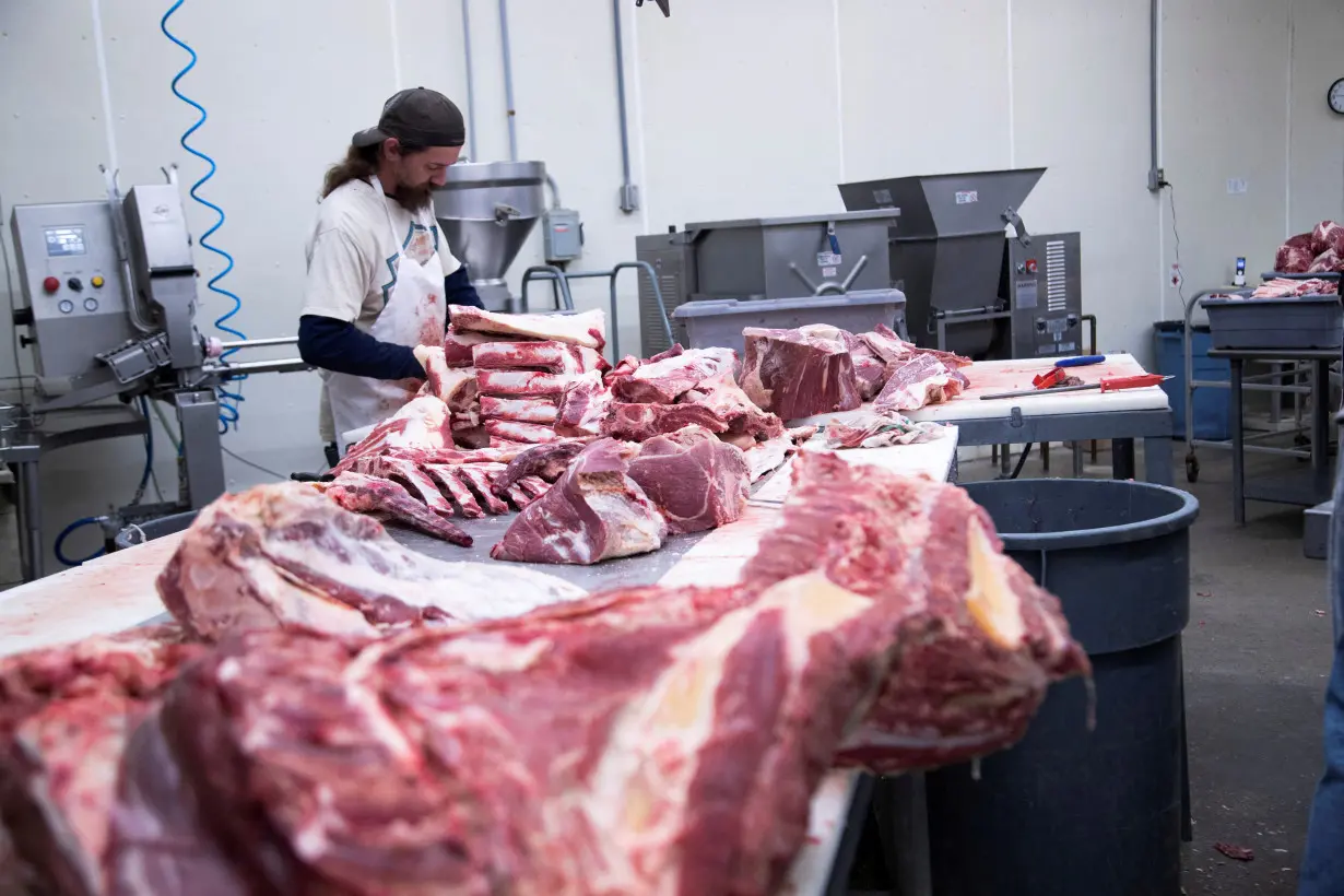 FILE PHOTO: Employee cuts fresh beef into large pieces