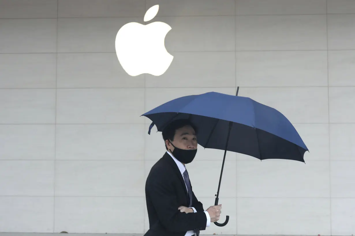 FILE PHOTO: Man walks past an Apple store in Taipei