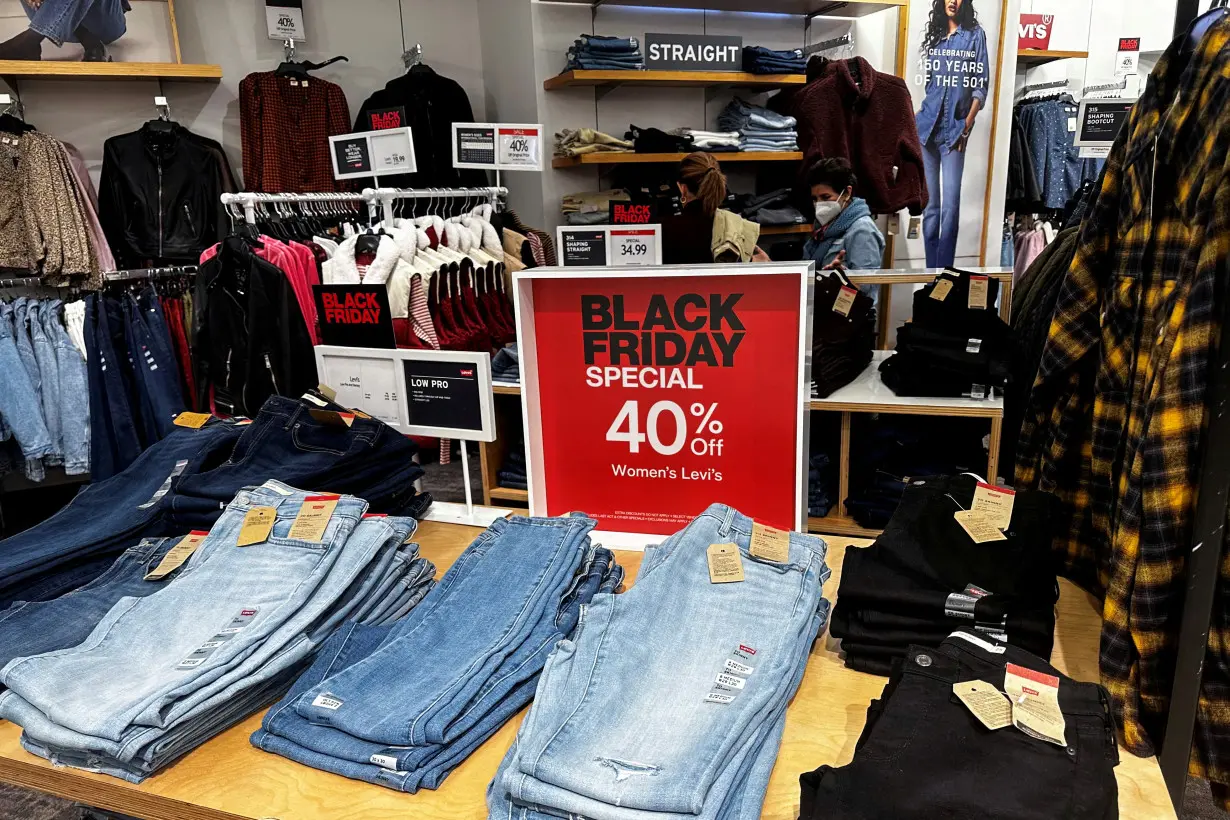 FILE PHOTO: Shoppers look at clothes during Black Friday deals at Macy’s department store at the Roosevelt Field mall in Garden City