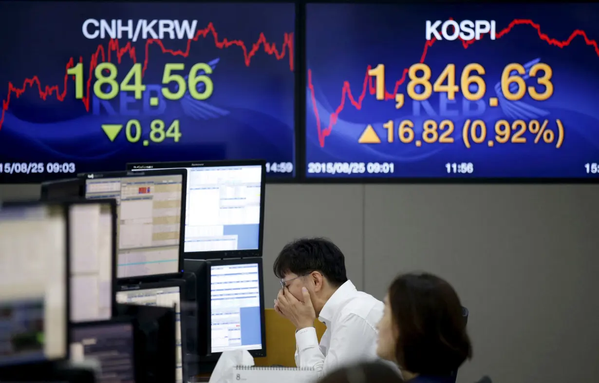 FILE PHOTO: A currency dealer works at dealing room of bank in Seoul