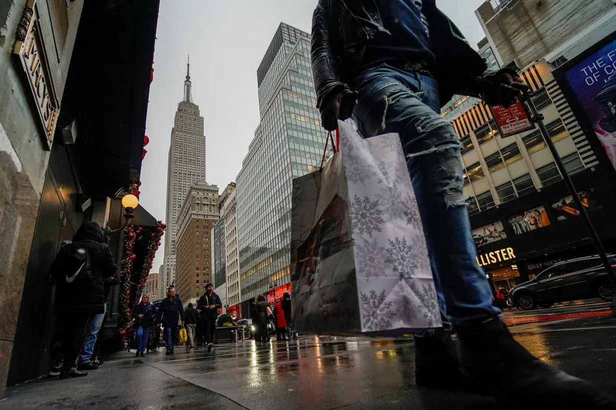 FILE PHOTO: People carry shopping bags during the holiday season in New York