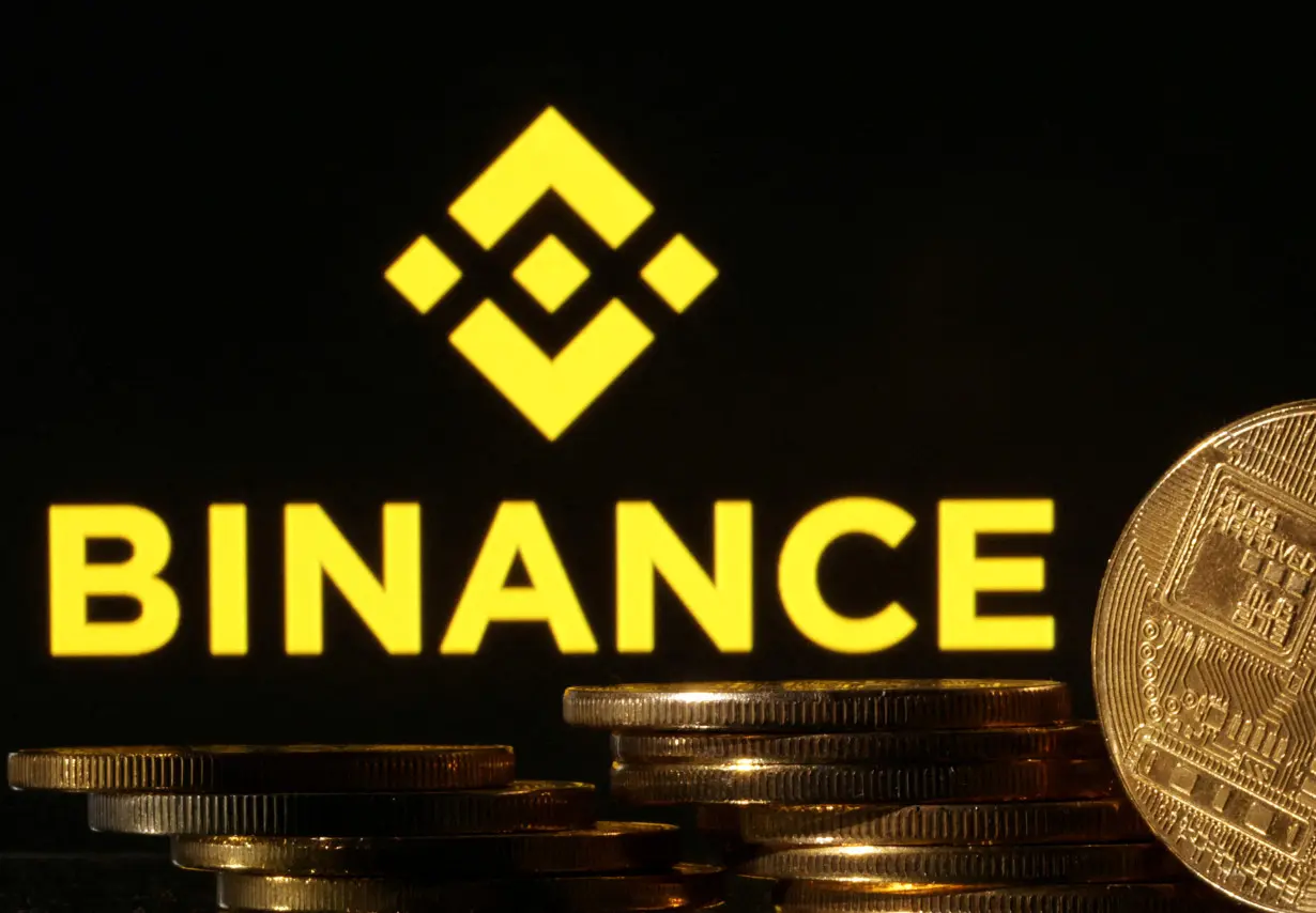 FILE PHOTO: Illustration shows Binance logo and representation of cryptocurrencies