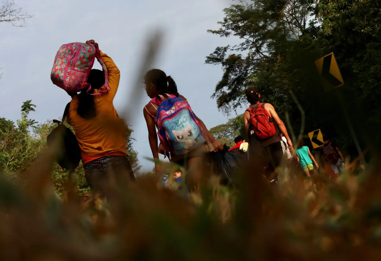 Migrants continue walking in a caravan to reach the U.S. border through Mexico, in Escuintla