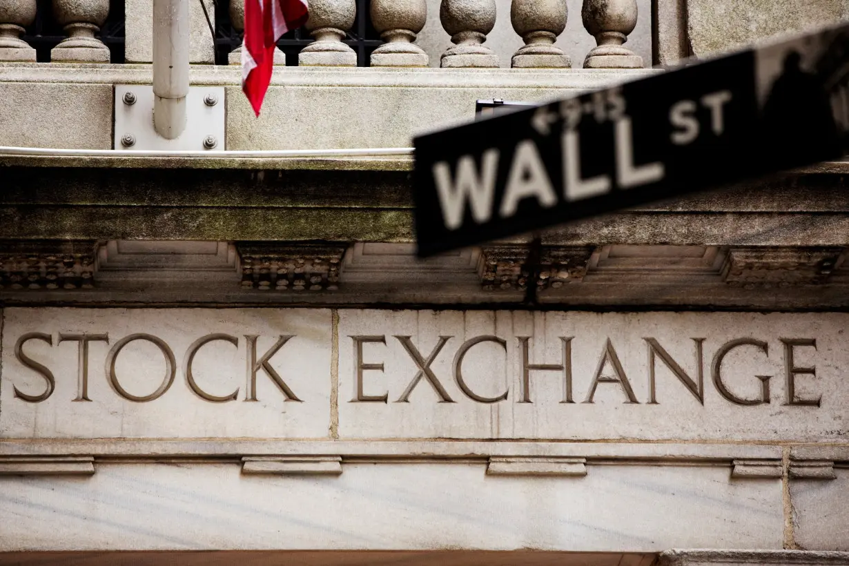 FILE PHOTO: A street sign for Wall Street hangs in front of the New York Stock Exchange