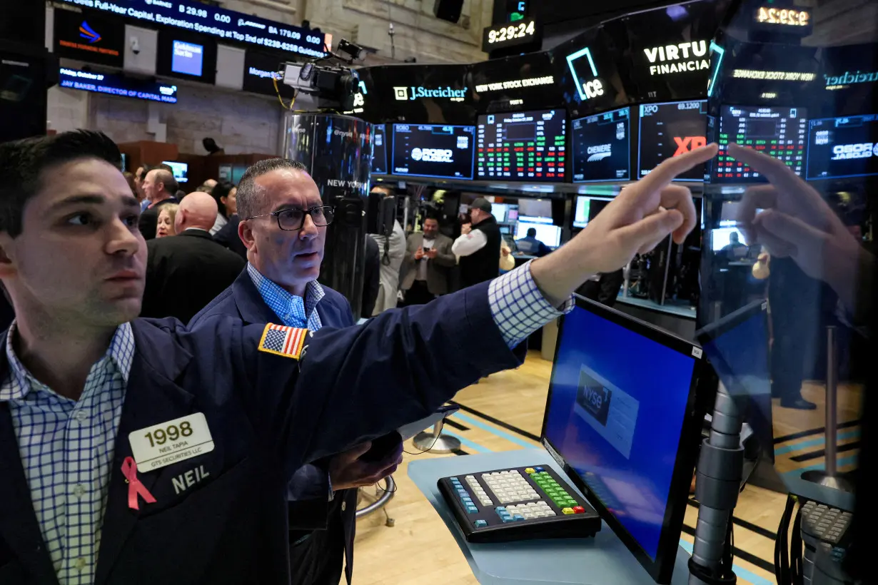 FILE PHOTO: Traders work on the floor of the NYSE in New York