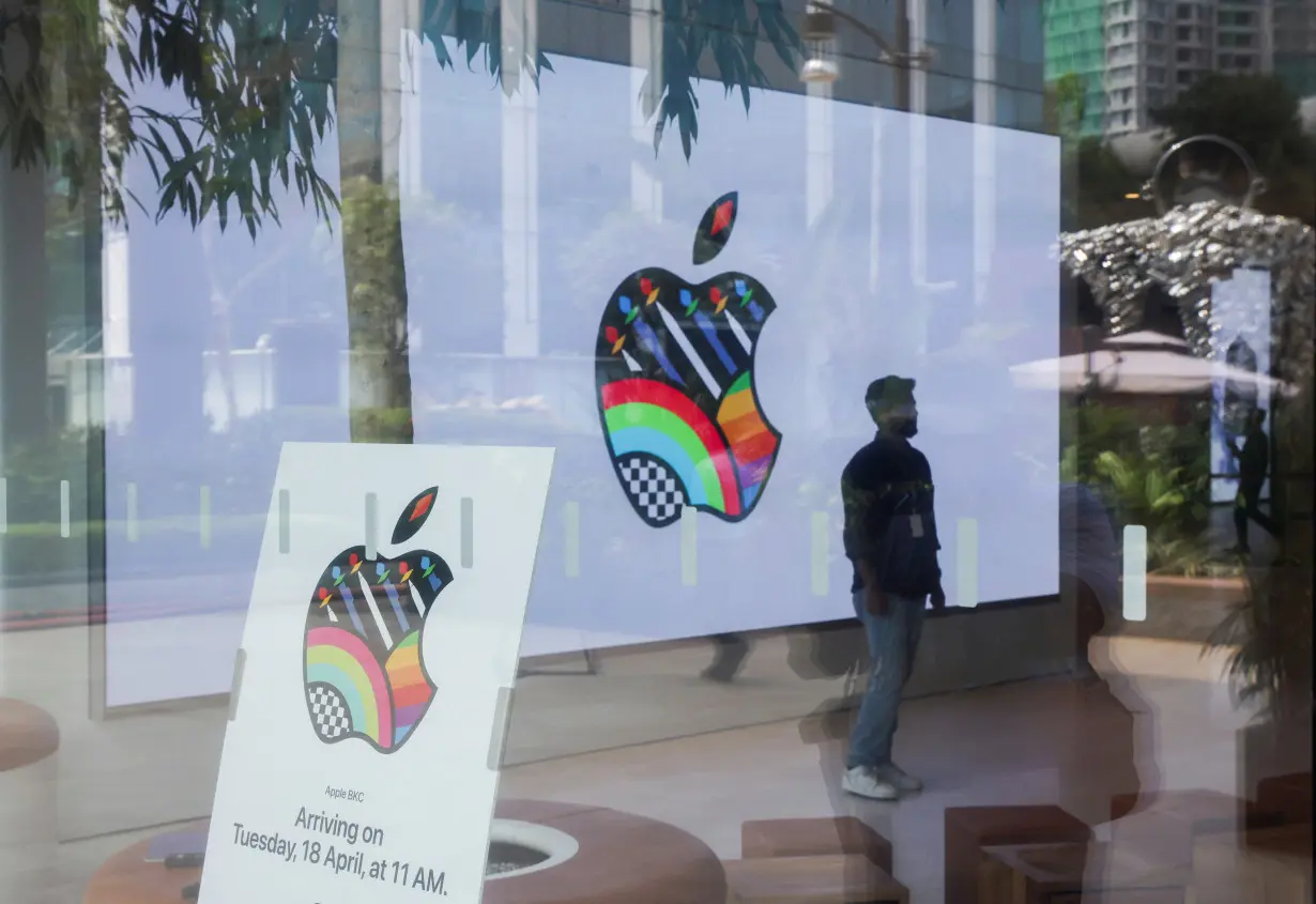 Man stands inside India's first Apple retail store during a media preview, a day ahead of its launch, in Mumbai