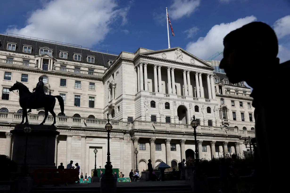 FILE PHOTO: Pedestrian walks past the Bank of England in London