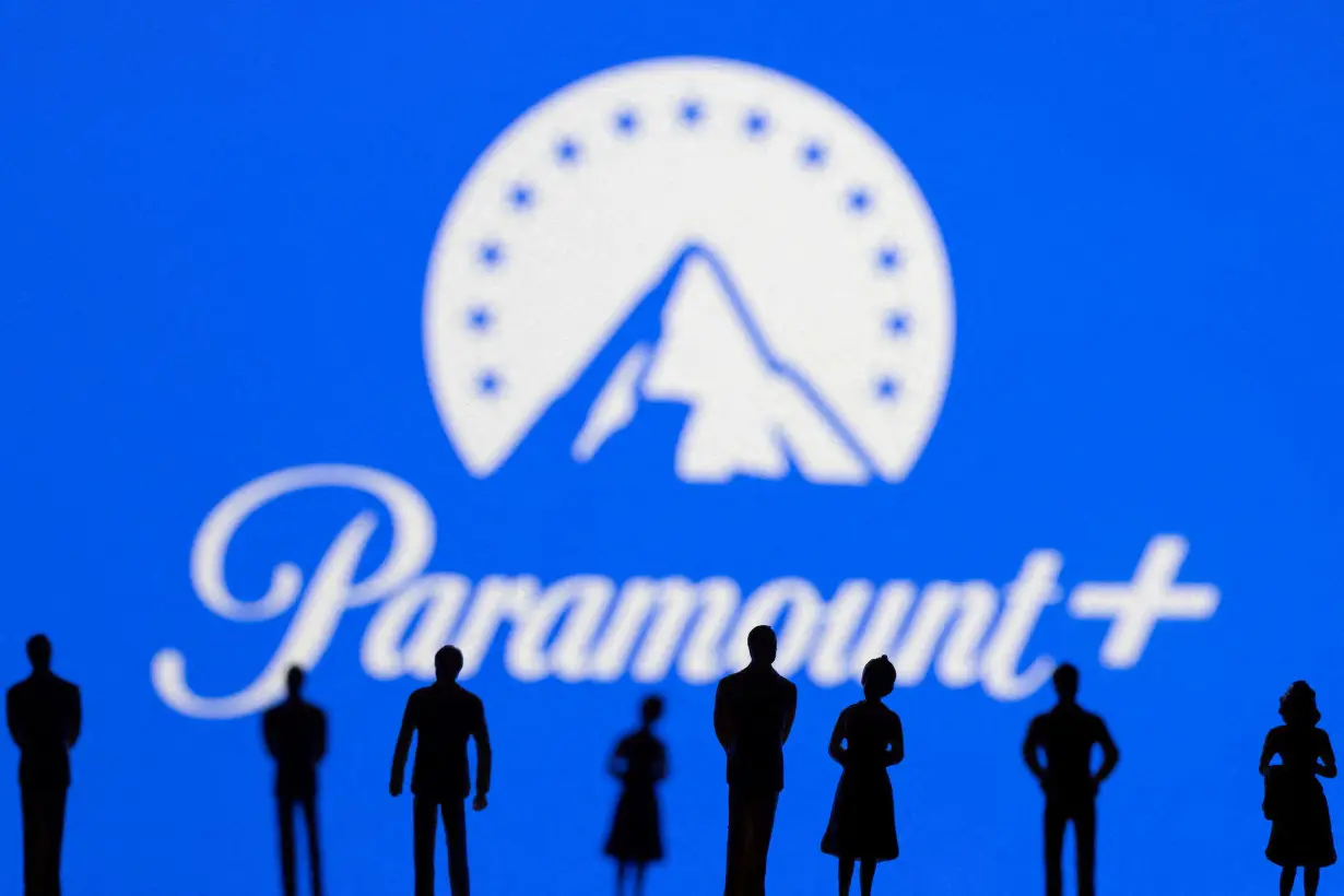 FILE PHOTO: Toy figures of people are seen in front of the displayed Paramount logo