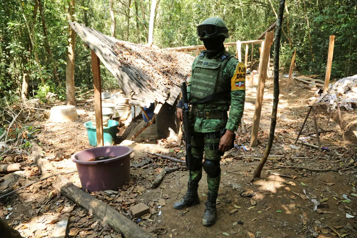 FILE PHOTO: A soldier keeps watch at an area where military authorities eradicated a coca leaf plantation and dismantled a lab to process the drug, in El Porvenir