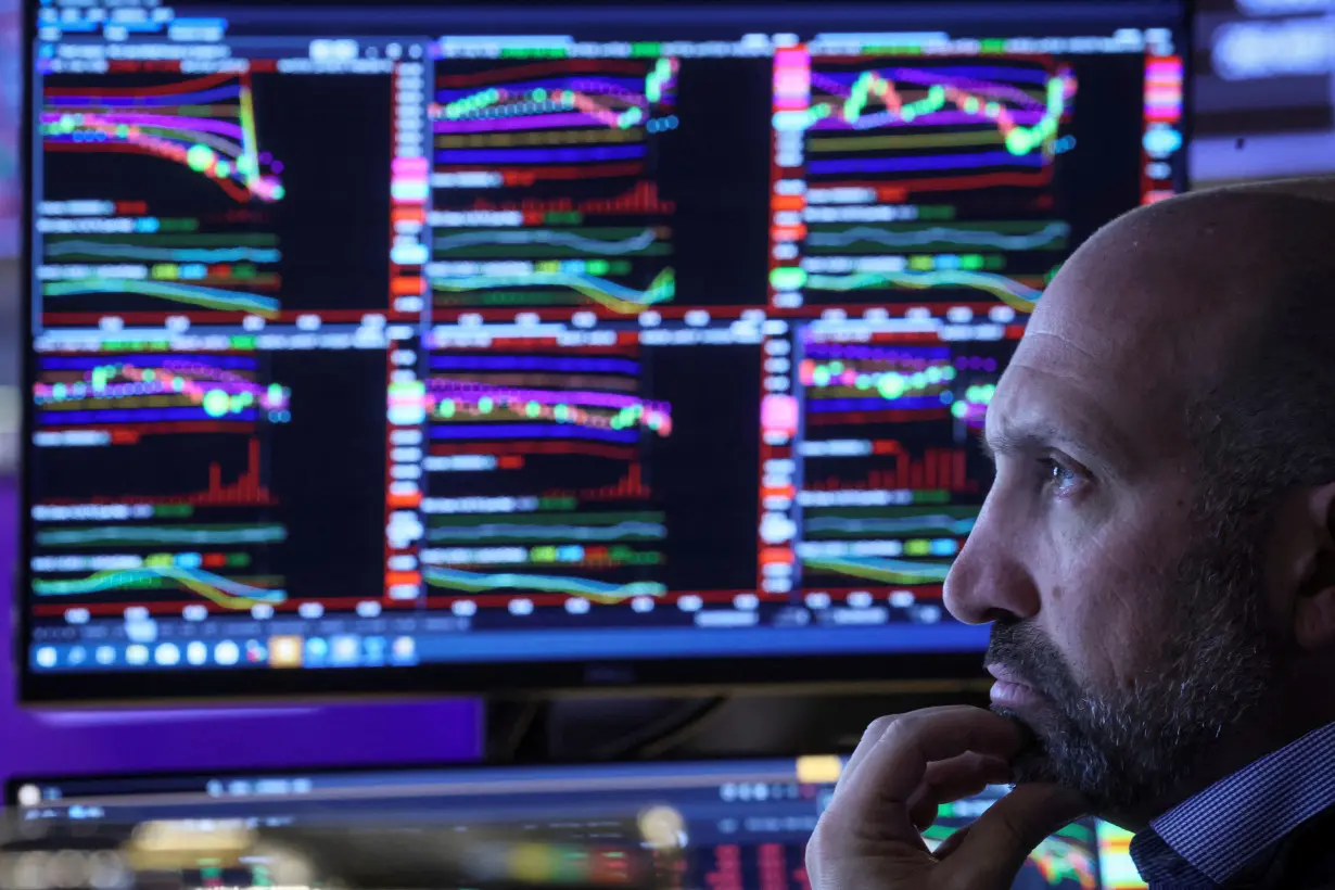 Traders work on the floor of the NYSE in New York