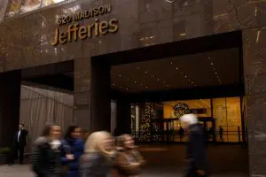 FILE PHOTO: People walk outside of Jefferies Financial Group offices in Manhattan, New York