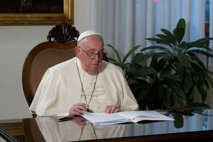 FILE PHOTO: Pope Francis signs a unified faith declaration on climate action as part of the inauguration of the "Faith Pavilion" during COP28 in Dubai, at Casa Santa Marta
