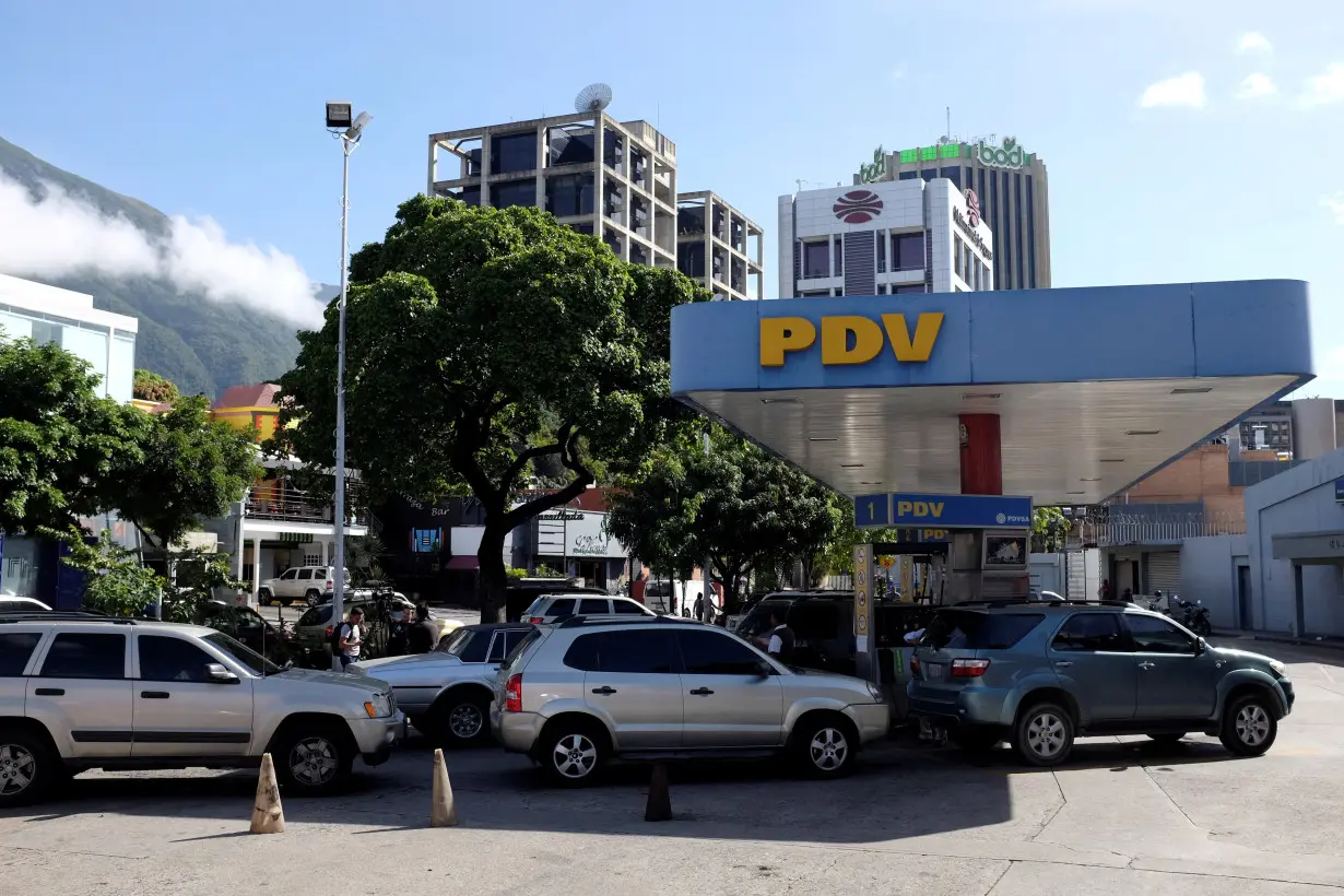 FILE PHOTO: Motorists line up for fuel at a gas station of the Venezuelan state-owned oil company PDVSA in Caracas