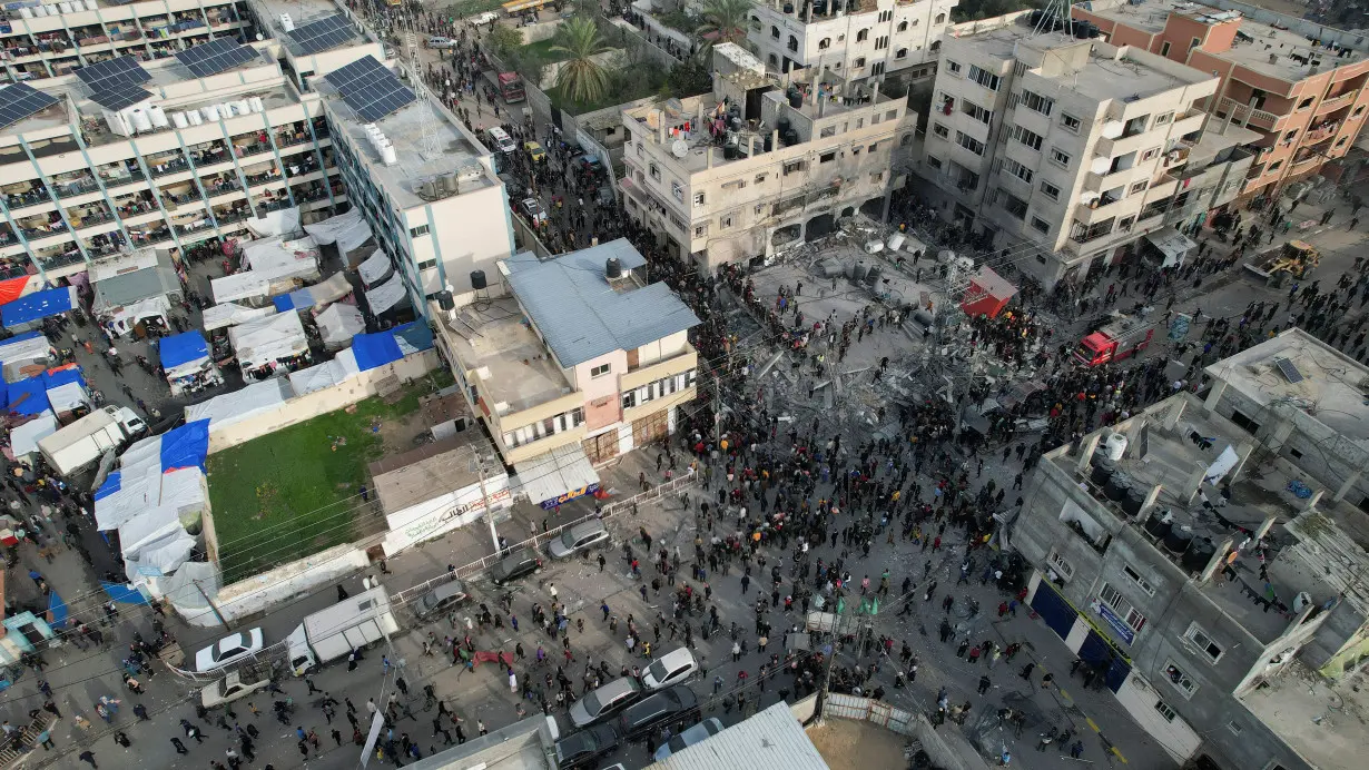 Palestinians gather at the site of an Israeli strike on a mosque, in Rafah