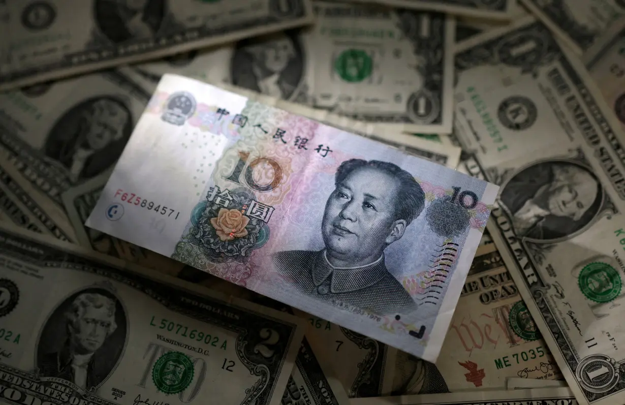 FILE PHOTO: Illustration shows Chinese Yuan and U.S. dollar banknotes