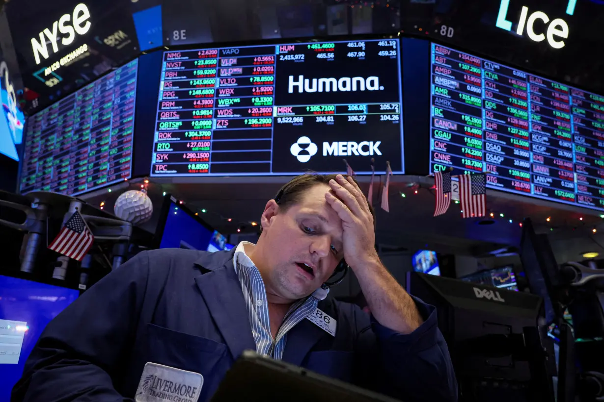 FILE PHOTO: Traders work on the floor of the NYSE in New York