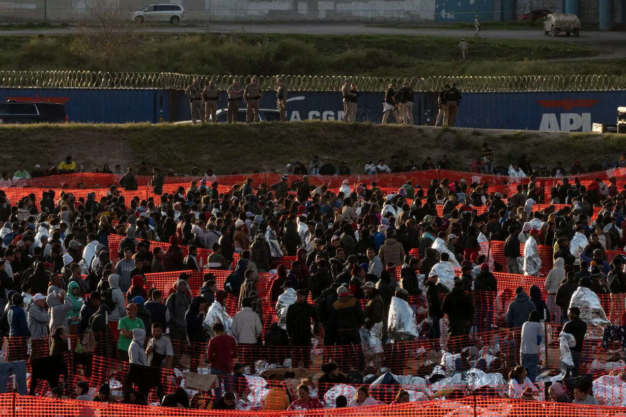 Migrants cross from Mexico into Eagle Pass, Texas