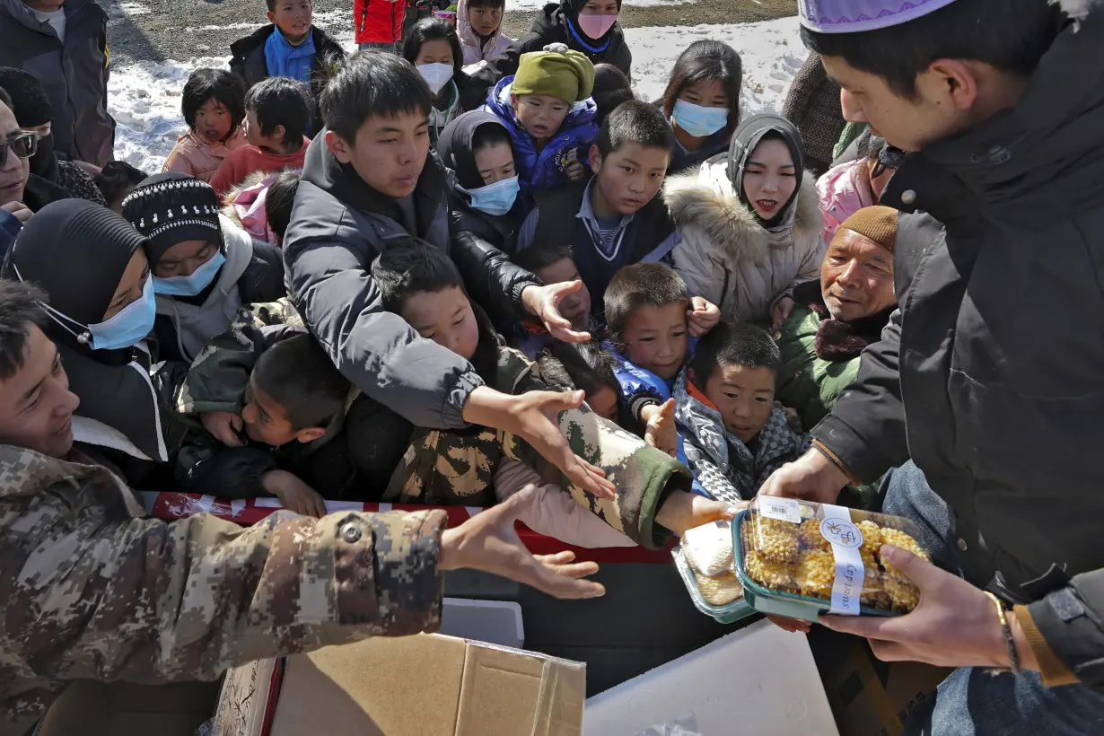 China has started erecting temporary housing units after an earthquake destroyed 14,000 homes