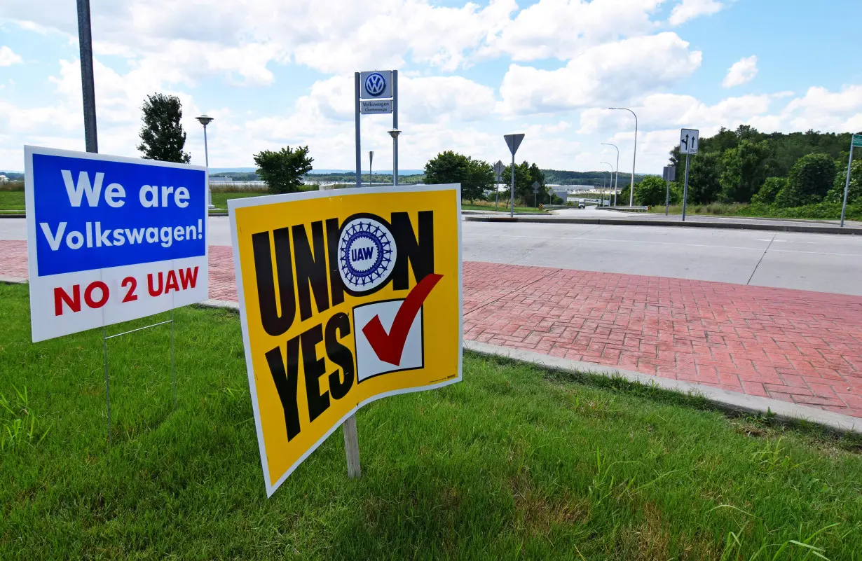 FILE PHOTO: Signs stand outside a Volkswagen plant during a vote among local workers over whether or not to be represented by the United Auto Workers union in Chattanooga,