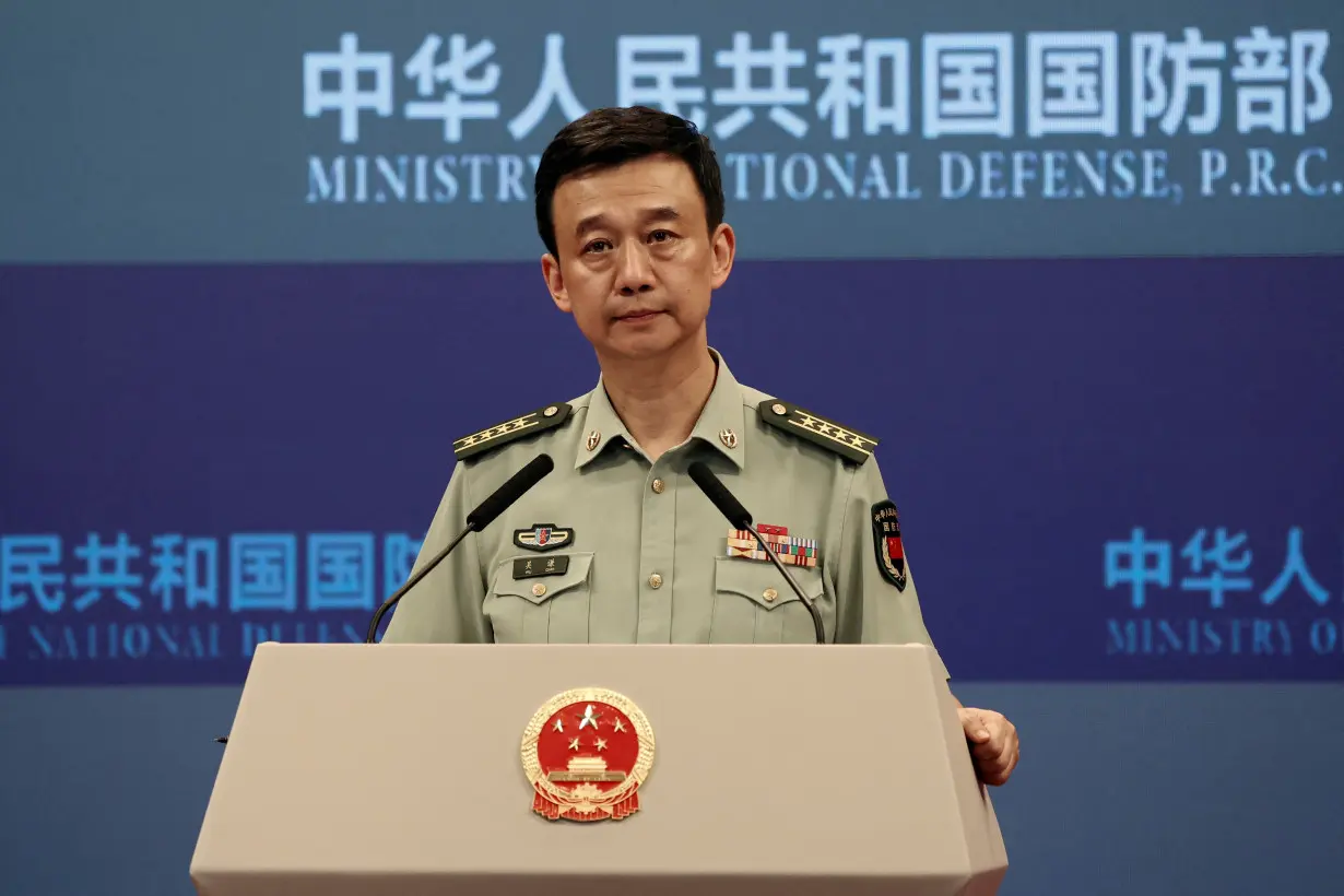 FILE PHOTO: Chinese Defence Ministry spokesperson Wu Qian attends a press briefing in Beijing