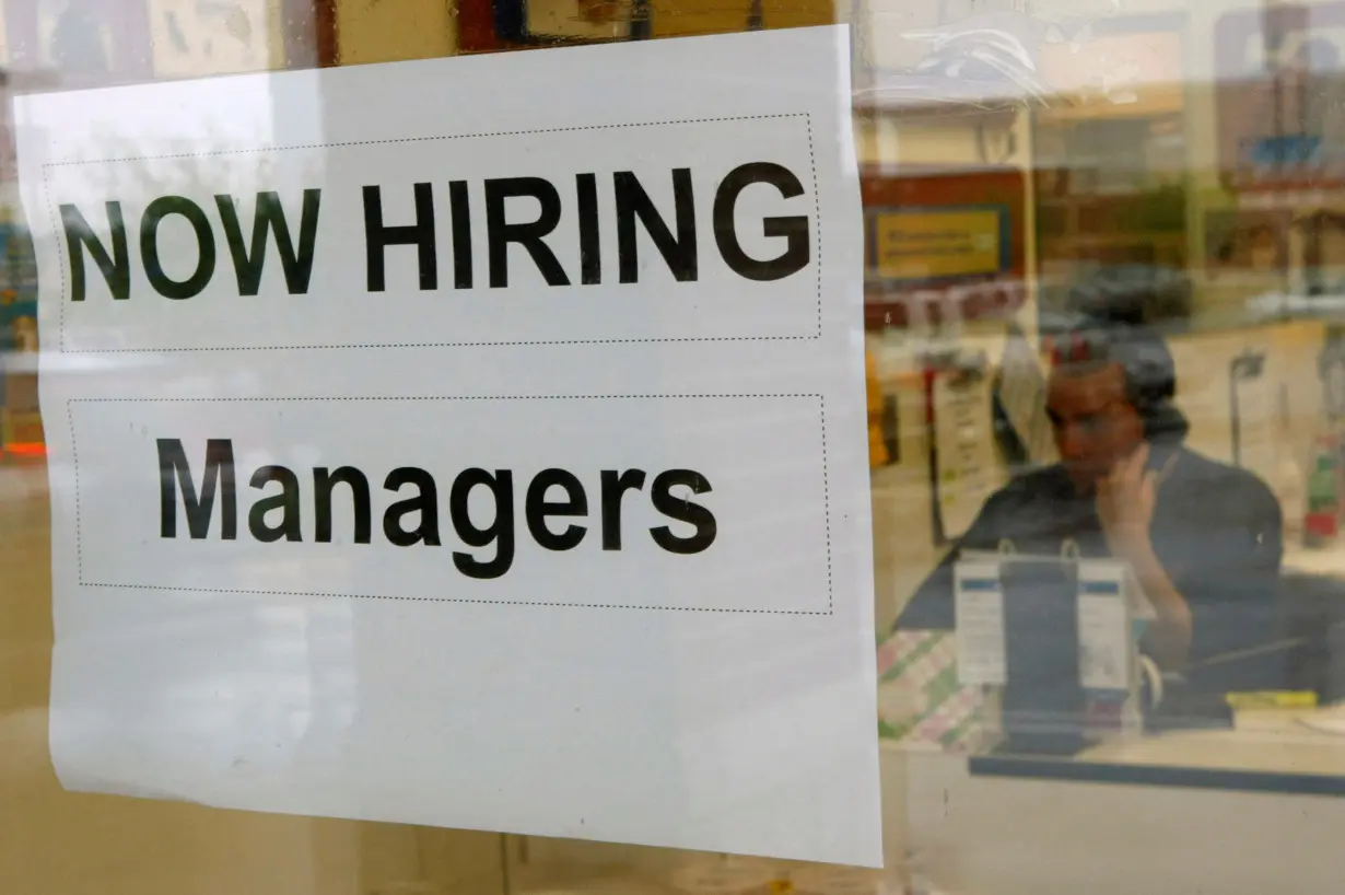 FILE PHOTO: A hiring sign hangs in a window in Virginia