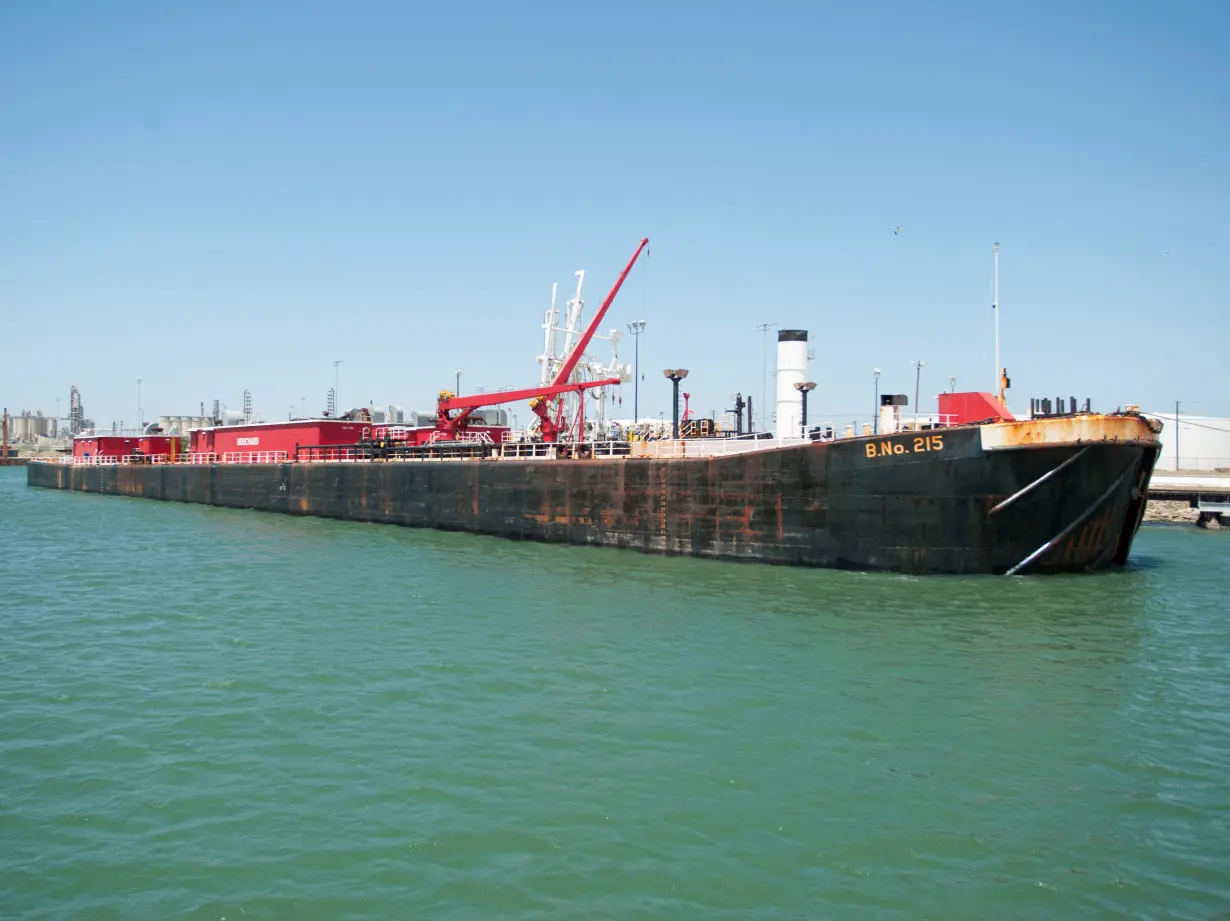 FILE PHOTO: A seagoing barge is loaded with crude oil from the Eagle Ford Shale formation at the newly expanded crude dock at the Port of Corpus Christi