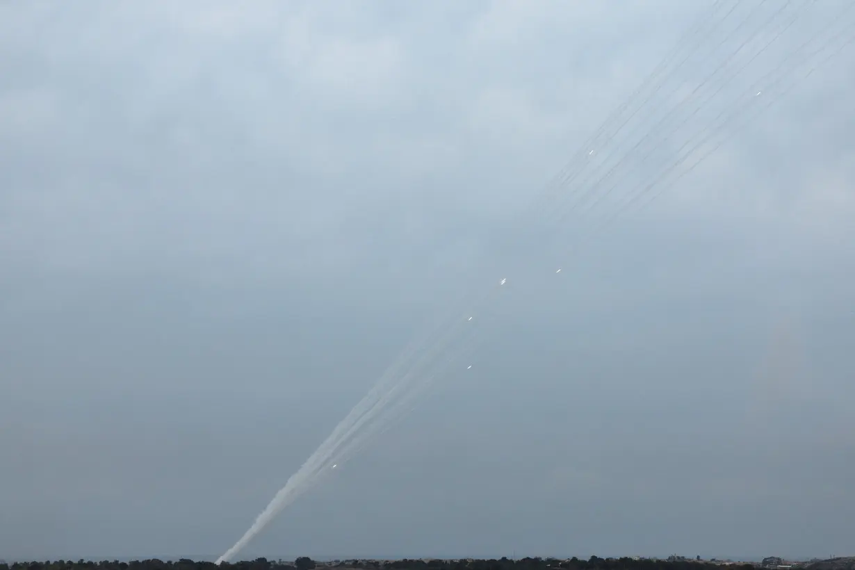 Smoke trails are seen as a salvo of rockets are launched from the Gaza Strip into Israel, as seen from southern Israel