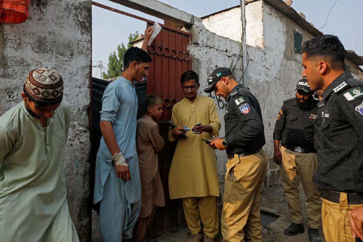 Police conduct a search and verification drive for undocumented Afghan nationals, on the outskirts of Karachi