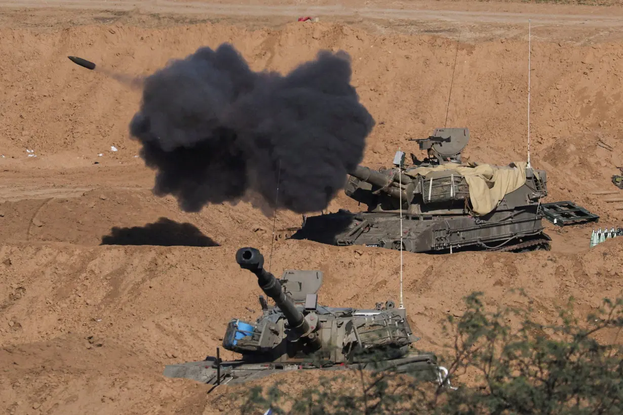 An Israeli self-propelled artillery unit fires as seen from southern Israel