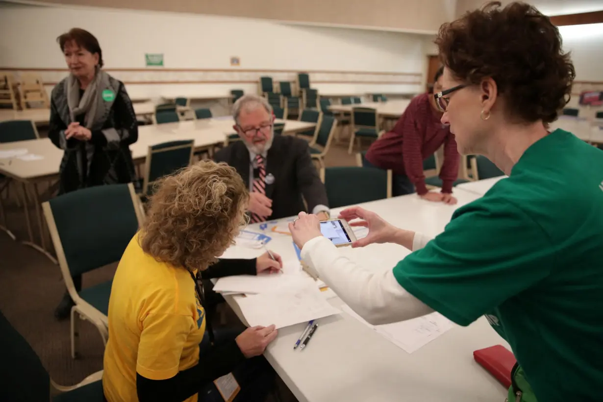 FILE PHOTO: Precinct workers count Iowa Democratic Caucus paper ballots after a Democratic presidential caucus in West Des Moines, Iowa