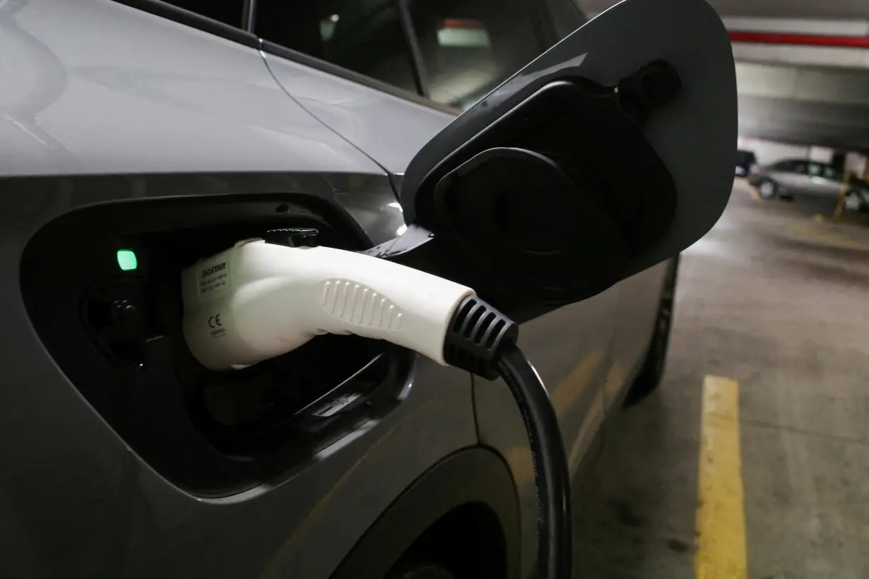 FILE PHOTO: A charging handle recharges a Volkswagen ID.4 electric vehicle parked at an EV charging station in Baltimore