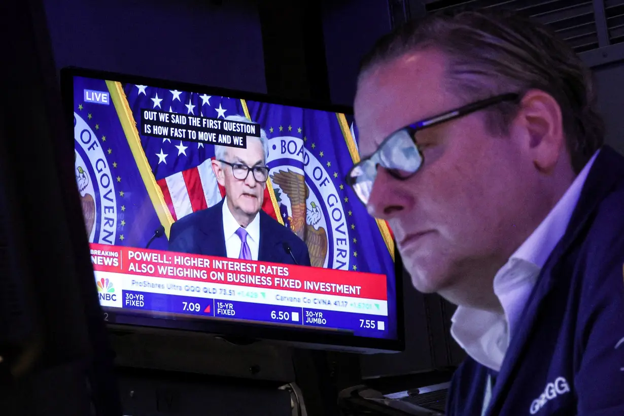 Traders react to Fed rate announcement on the floor of the NYSE in New York