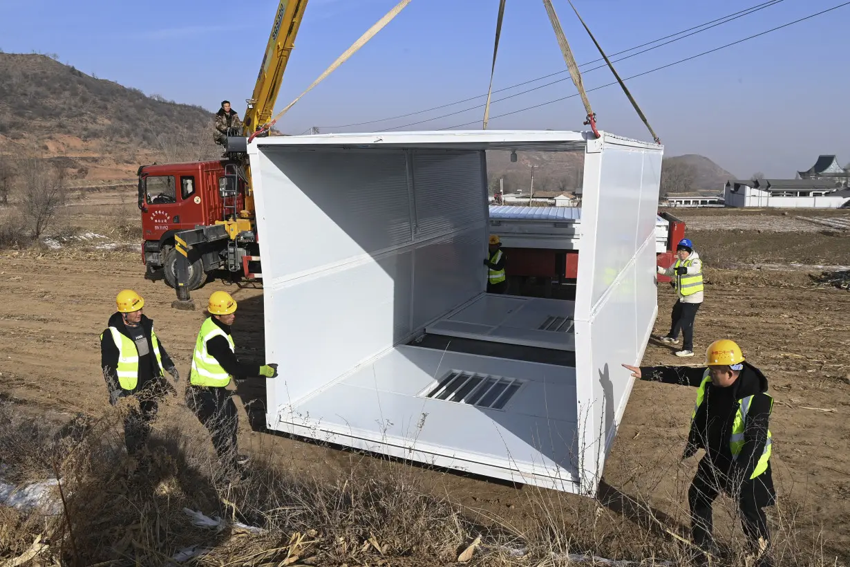 China has started erecting temporary housing units after an earthquake destroyed 14,000 homes