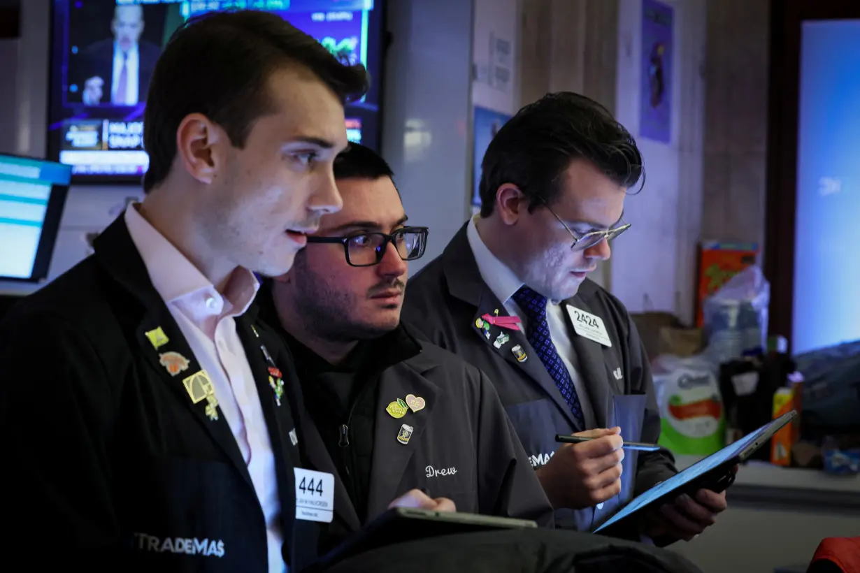 Traders work on the floor of the NYSE in New York