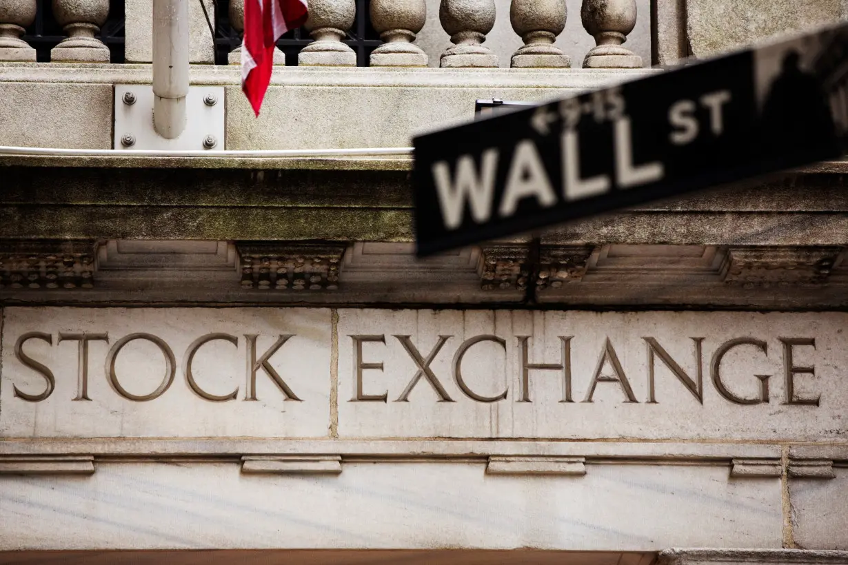 FILE PHOTO: A street sign for Wall Street hangs in front of the New York Stock Exchange