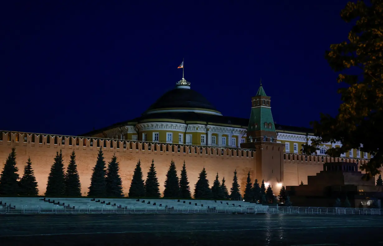 The Russian flag flies on the dome of the Kremlin Senate building in Moscow