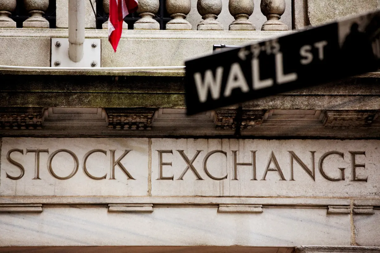 FILE PHOTO: A street sign for Wall Street hangs in front of the New York Stock Exchange